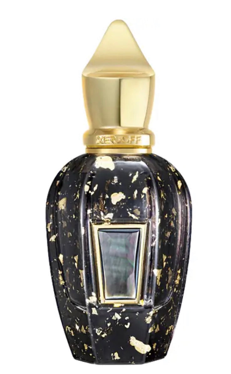 Perfume bottle with gold cap and black and gold speckled body on a white background