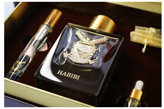Habibi perfume bottle with gold cap and packaging on a dark surface