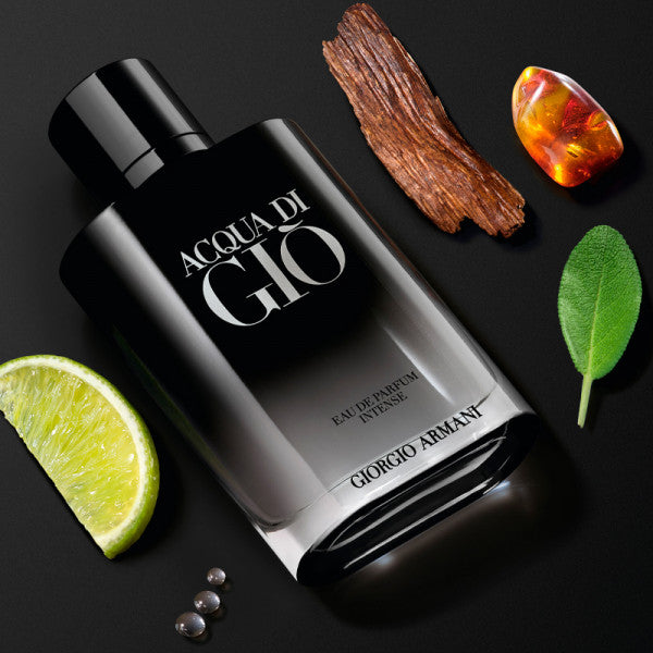 Giorgio Armani Acqua di Gio perfume bottle with lime, amber, and leaf on a black background