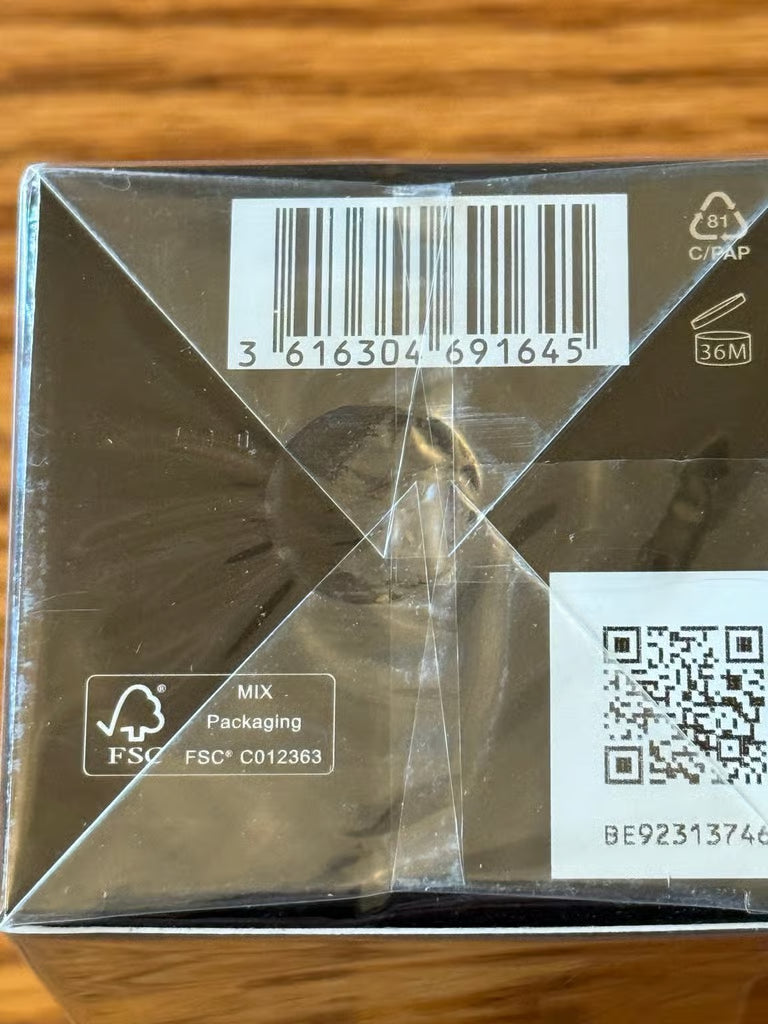 Product packaging with barcode and QR code on a wooden surface