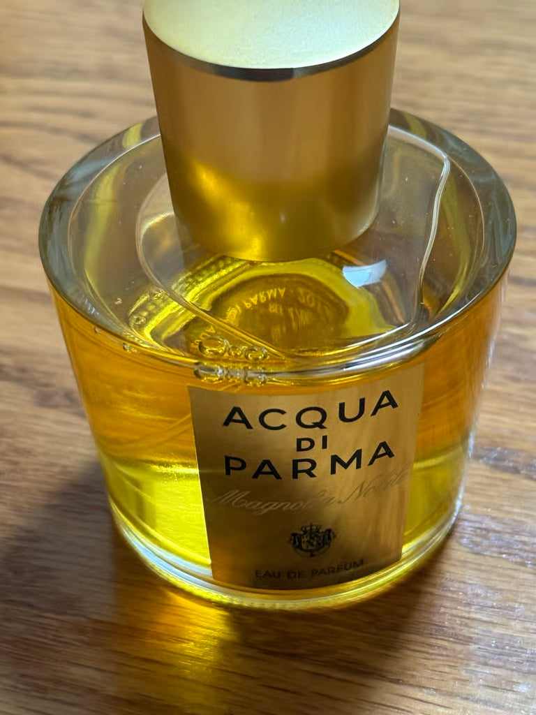 Acqua di Parma perfume bottle on a wooden surface