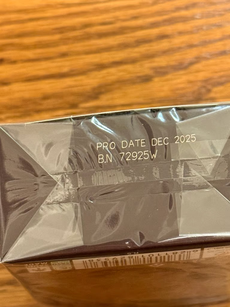 Product packaging with 'PRO DATE DEC 2025' and 'B.N. 72925W' text on a wooden surface.