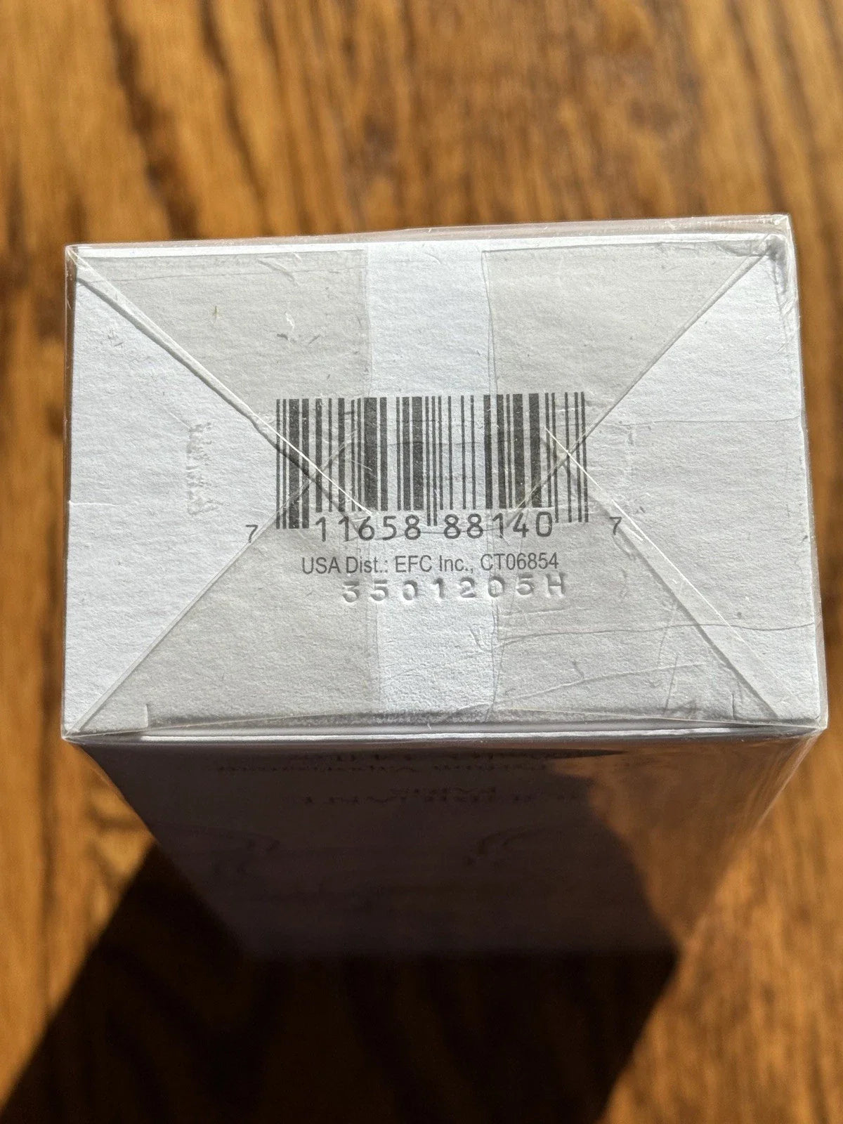 Small cardboard box with a barcode on a wooden surface